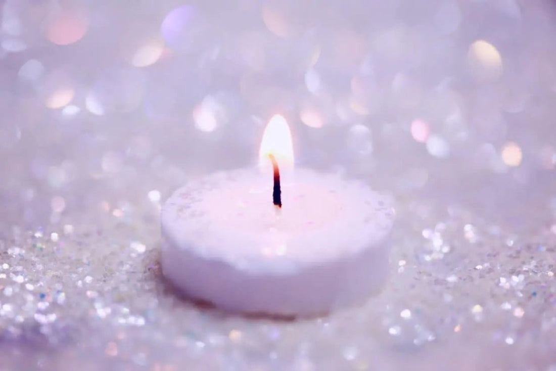 tea candle on glittery background
