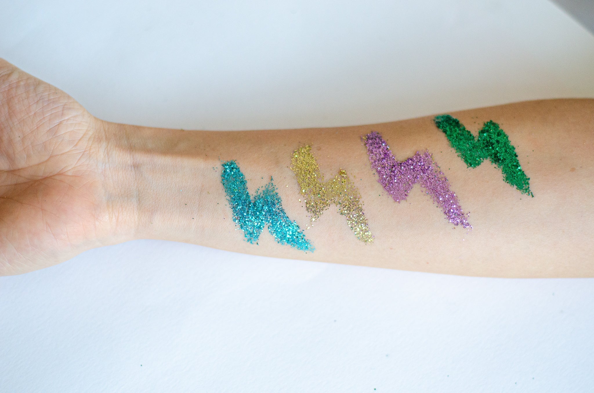 forearm with lighting bold glitter tattooes