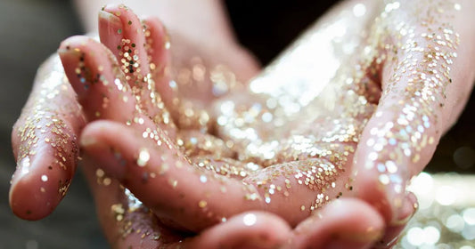 Cupped hands holding silver glitter