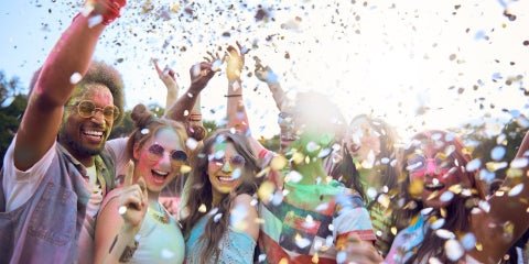 crowd in a festival with confetti in the air