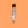 Small glass vial with glitter on an orange background