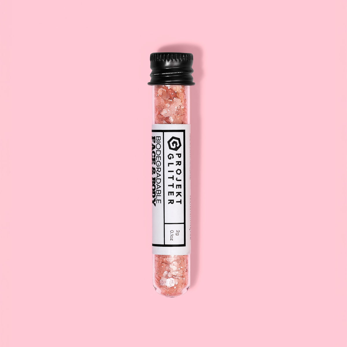 Test tube with pink glitter labeled 'Projekt Glitter' on a pink background