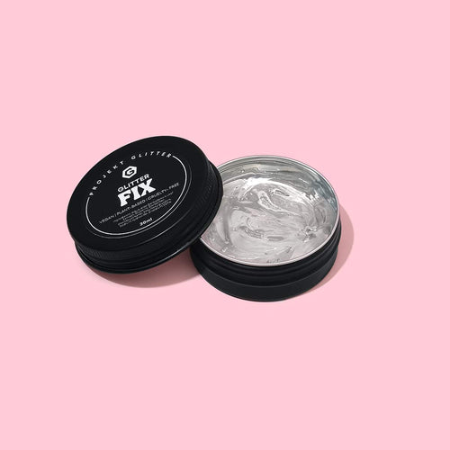 Container of 'Glitter Fix' glitter glue on a pink background