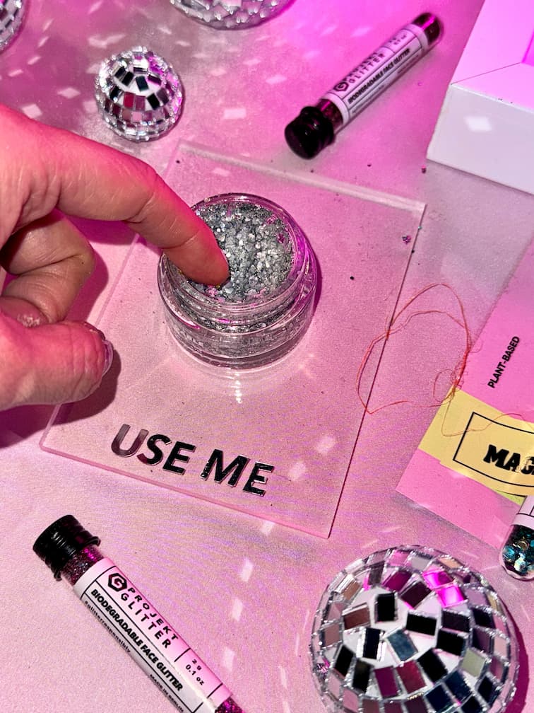 finger removing glitter gel from glitter bar